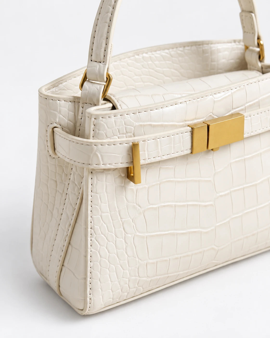 Delphine Croc Top Handle Bag in White — croc-effect texture and gold-tone closure detail