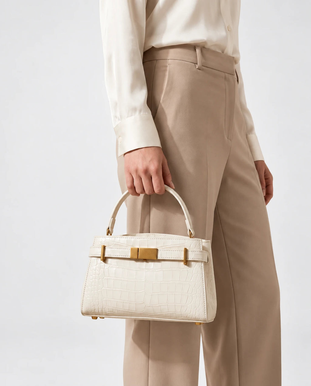 Delphine Croc Top Handle Bag in White — worn on the shoulder for scale