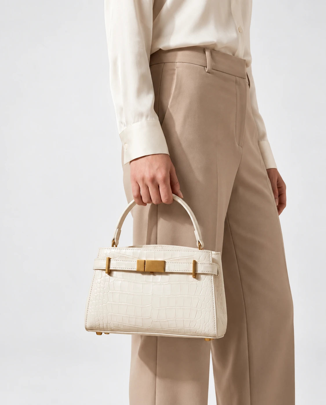 Delphine Croc Top Handle Bag in White — worn on the shoulder for scale