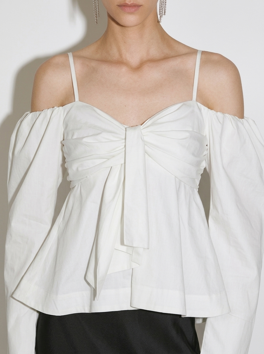 white blouse with a large front bow